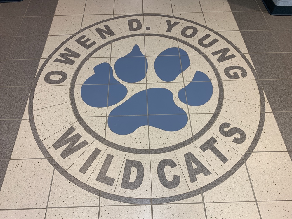 a blue pawprint made out of tile is surrounded by the words Owen D. Young Wildcats
